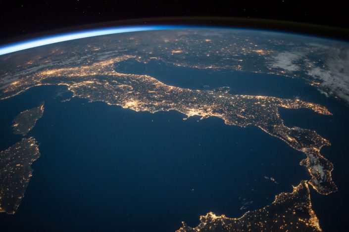An image from outer-space at night showing the lights in Italy
