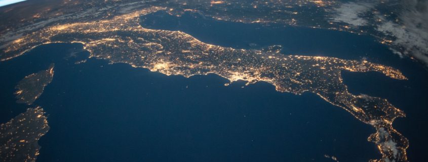 An image from outer-space at night showing the lights in Italy