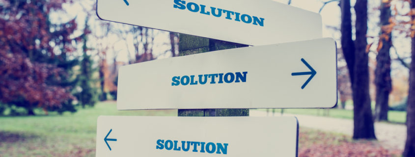 A sign post with signs pointing in multiple direction that all say SOLUTION