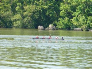 A group of women on a crew team rowing on the Anacostia river
