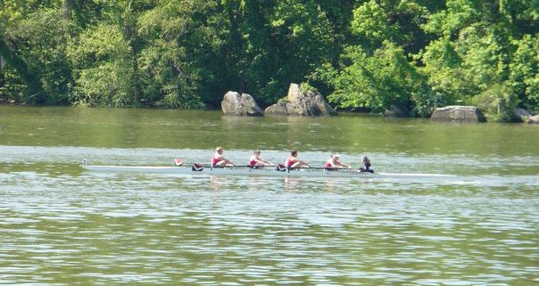 A group of women on a crew team rowing on the Anacostia river