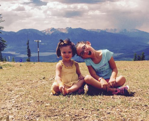 Photo of 2 young girls in front of Colorado Mountains