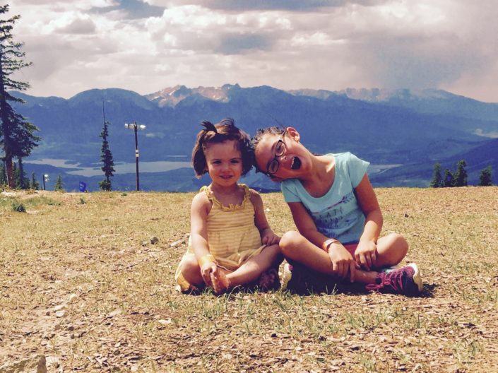 Photo of 2 young girls in front of Colorado Mountains