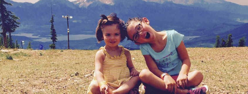 Photo of 2 young girls in front of Colorado Mountains