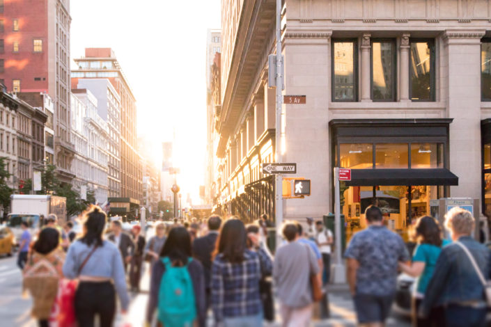 people walking across a busy intersection