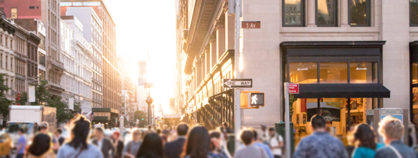 people walking across a busy intersection