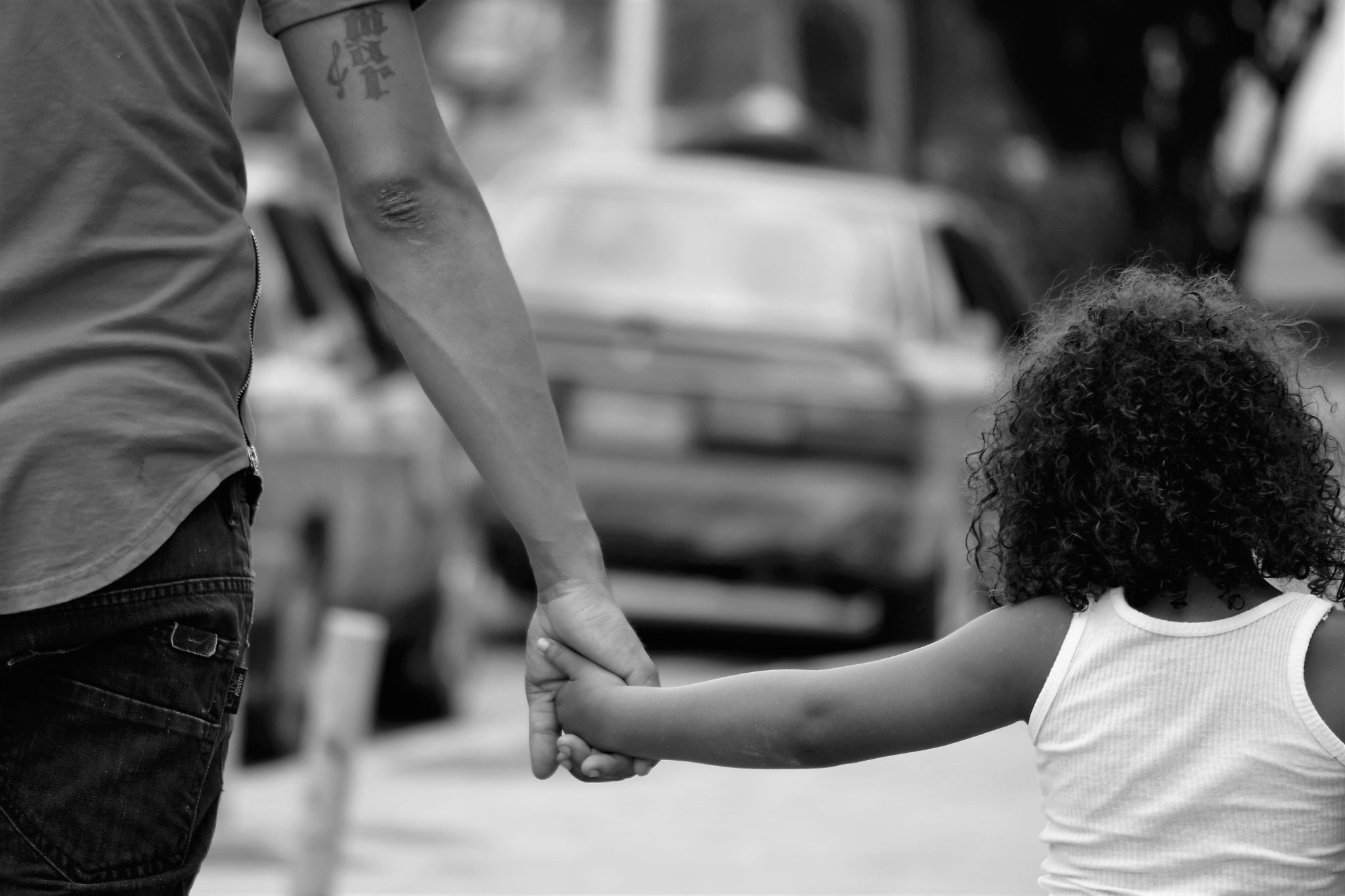 grayscale-photography-of-father-and-daughter-holding-each-1301498