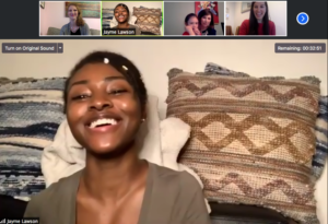 A screenshot from a zoom meeting of a woman laughing