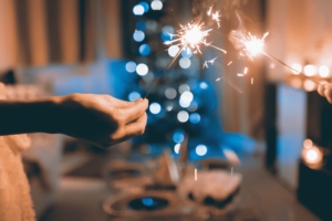 hands holding sparklers with a blurred background