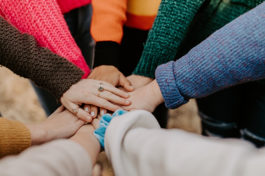 Close up of people making a stack of hands.