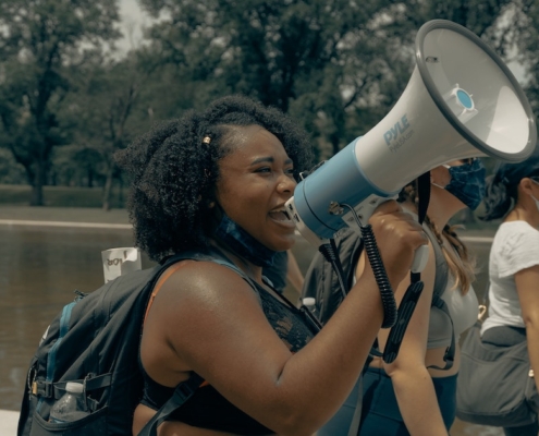 a Black women with a megaphone on a protest march