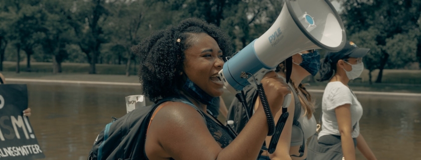 a Black women with a megaphone on a protest march