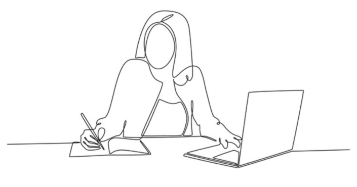 women sitting and writing in a book while typing on the computer with the other hand - she is facing the camera