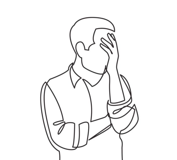 Man upset, holding head in hand.