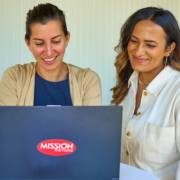 two women working at a laptop